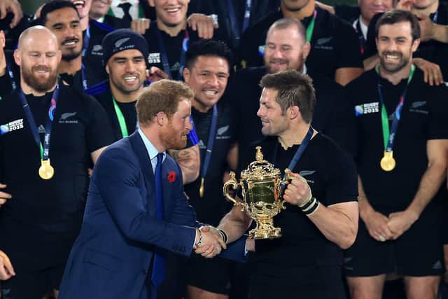 Prince Harry presents New Zealand captain Richie McCaw with the Webb Ellis Trophy after the All Blacks' victory over Australia in the 2015 Rugby World Cup final at Twickenham. Picture: Mike Egerton/PA Wire