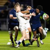 Scotland's Amena Caqusau tries to shake off the attentions of England's Ioan Jones and Ben Redshaw at the Hive Stadium.