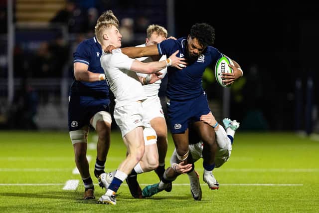 Scotland's Amena Caqusau tries to shake off the attentions of England's Ioan Jones and Ben Redshaw at the Hive Stadium.