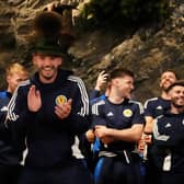 Scotland's John McGinn (centre) joins in with a dance as the team arrive at Bayernhalle in Garmisch-Partenkirchen, Germany, for a reception hosted by the Mayor.