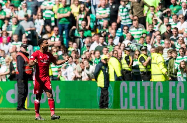 Aberdeen's Shay Logan gestures to the Celtic fans (Picture: SNS)