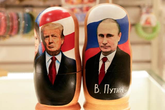 Traditional Russian wooden nesting dolls depicting Russia's President Vladimir Putin and US President Donald Trump in downtown Moscow (Picture: Tatyana Makeyeva/Getty Images)