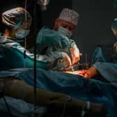 Surgeons perform an operation on the leg of a wounded Ukrainian soldier at a military hospital in Zaporizhzhia.