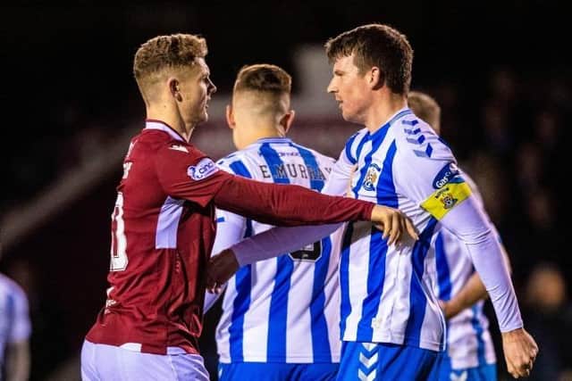 Arbroath’s Jack Hamilton and Kilmarnock’s Chris Stokes during a cinch Championship match between Arbroath and Kilmarnock at Gayfield Park, on February 04, 2022, in Arbroath, Scotland.  (Photo by Ross MacDonald / SNS Group)