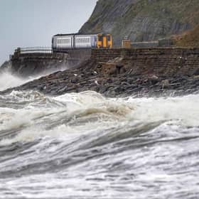 A train heads along the west coast between Whitehaven and Carlisle after Storm Dudley hit the north of the country last night. Picture date: Thursday February 17, 2022.