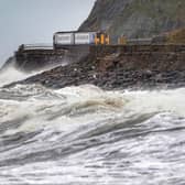 A train heads along the west coast between Whitehaven and Carlisle after Storm Dudley hit the north of the country last night. Picture date: Thursday February 17, 2022.