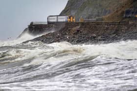 A train heads along the west coast between Whitehaven and Carlisle after Storm Dudley hit the north of the country last night. Picture date: Thursday February 17, 2022.