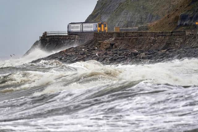 A train heads along the west coast between Whitehaven and Carlisle after Storm Dudley hit the north of the country last night. Picture date: Thursday February 17, 2022.