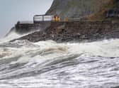 A train heads along the west coast between Whitehaven and Carlisle after Storm Dudley hit the north of the country last night. Picture date: Thursday February 17, 2022.