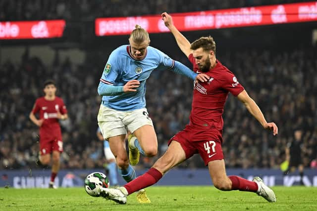 Liverpool defender Nat Phillips (left) is closing in on a loan move to Celtic. (Photo by OLI SCARFF/AFP via Getty Images)