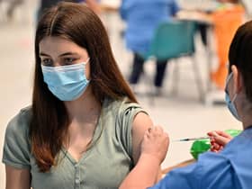 Teenager Katie Moore receives a covid-19 vaccine at a vaccination centre in Barrhead, south of Glasgow on August 9, 2021. Photo by JEFF J MITCHELL/POOL/AFP via Getty Images