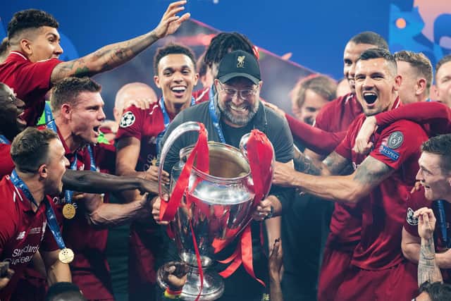 Jurgen Klopp lifts the Champions League trophy after guiding Liverpool to a 2-0 victory over Tottenham in the 2019 final. (Photo by Matthias Hangst/Getty Images)