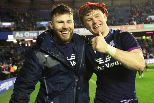 Darcy Graham, with natty headwear, celebrates with Ali Price at full-time.  (Photo by Craig Williamson / SNS Group)