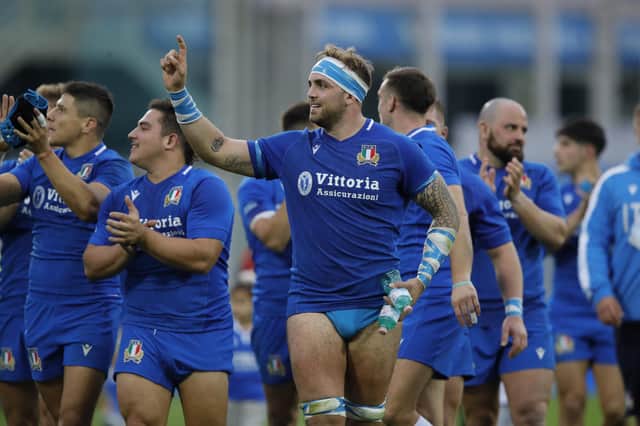 Niccolò Cannone celebrates during a lap of honour after Italy overcame Australia.