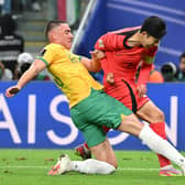 Australia defender Lewis Miller brings down South Korea's Son Heung-min to concede a 96th minute penalty. (Photo by HECTOR RETAMAL/AFP via Getty Images)