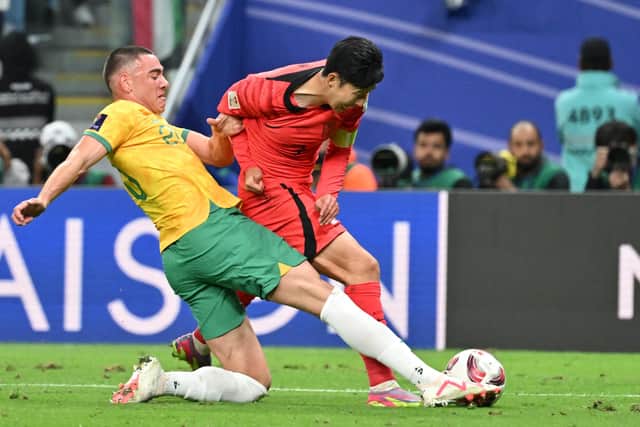 Australia defender Lewis Miller brings down South Korea's Son Heung-min to concede a 96th minute penalty. (Photo by HECTOR RETAMAL/AFP via Getty Images)