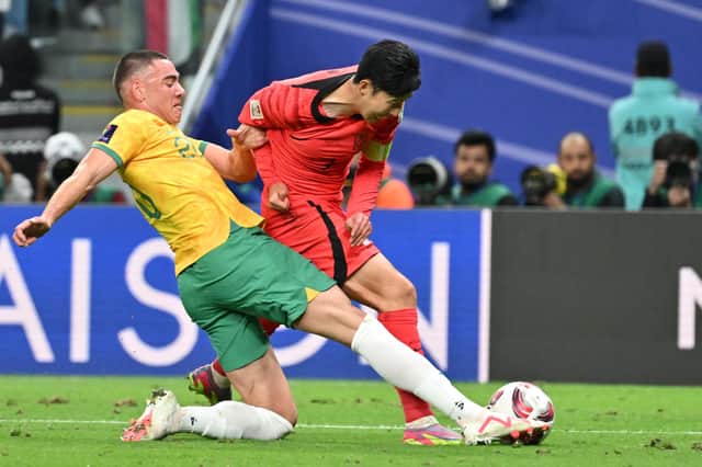 Australia defender Lewis Miller brings down South Korea's Son Heung-min to concede a 96th minute penalty. (Photo by HECTOR RETAMAL/AFP via Getty Images)