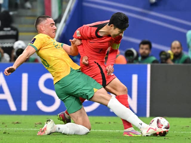 Australia defender Lewis Miller brings down South Korea's Son Heung-min to concede a 96th minute penalty. (Photo by HECTOR RETAMAL/AFP via Getty Images)