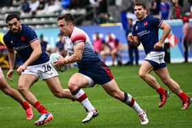 Ross McCann in action for Great Britain against France's Rayan Rebbadj and Antoine Dupont during the HSBC Rugby Sevens LA tournament in Carson, California on March 2, 2024.  (Photo by PATRICK T. FALLON/AFP via Getty Images)