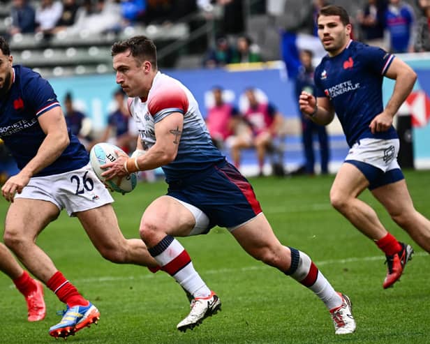 Ross McCann in action for Great Britain against France's Rayan Rebbadj and Antoine Dupont during the HSBC Rugby Sevens LA tournament in Carson, California on March 2, 2024.  (Photo by PATRICK T. FALLON/AFP via Getty Images)
