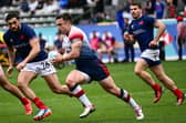 Ross McCann in action for Great Britain against France's Rayan Rebbadj and Antoine Dupont during the HSBC Rugby Sevens LA tournament in Carson, California on March 2, 2024.  (Photo by PATRICK T. FALLON/AFP via Getty Images)