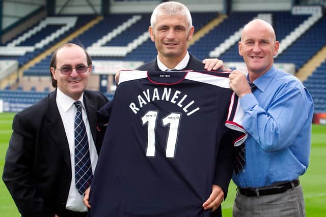 Fabrizio Ravanelli signs for Dundee in September 2003 after Giovanni di Stefano (left) promised to pay his wages. Manager Jim Duffy is on right