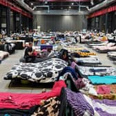 Refugees from Ukraine are pictured at the Humanitarian Aid Center set up at the Global Expo exhibition hall in Warsaw in July. The makeshift refugee centre was meant to be a temporary solution but many refugees have been there for months.