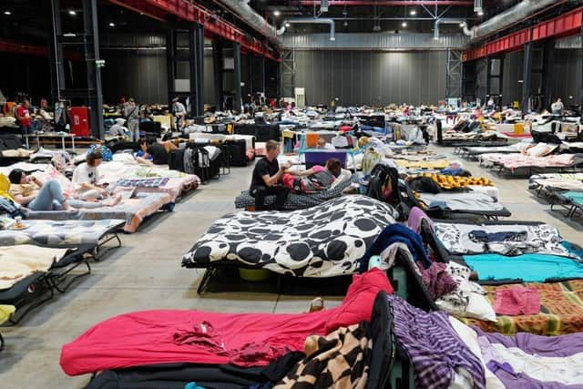 Refugees from Ukraine are pictured at the Humanitarian Aid Center set up at the Global Expo exhibition hall in Warsaw in July. The makeshift refugee centre was meant to be a temporary solution but many refugees have been there for months.