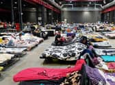 Refugees from Ukraine are pictured at the Humanitarian Aid Center set up at the Global Expo exhibition hall in Warsaw in July. The makeshift refugee centre was meant to be a temporary solution but many refugees have been there for months.