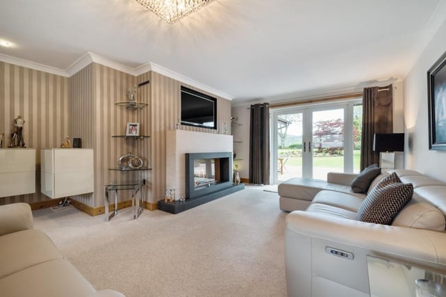Sitting room with feature fireplace and French doors to the garden.