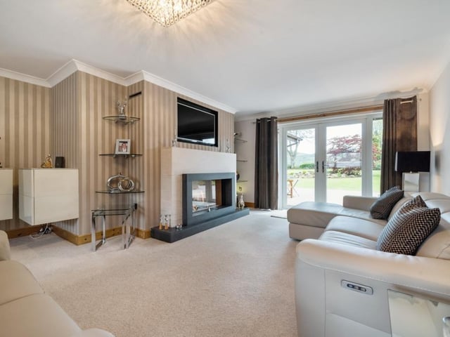 Sitting room with feature fireplace and French doors to the garden.