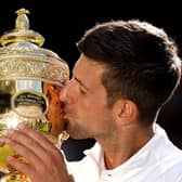 Novak Djokovic celebrates after his fourth Wimbledon men's singles triumph in a row.