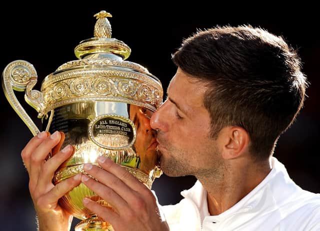 Novak Djokovic celebrates after his fourth Wimbledon men's singles triumph in a row.