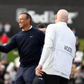 The smile on his face says it all as Tiger Woods shakes hands with Harry Diamond, Rory McIlroy's caddie, after finishing with three straight birdies in the first round of The Genesis Invitational at Riviera Country Club in Pacific Palisades, California. Picture: Michael Owens/Getty Images.