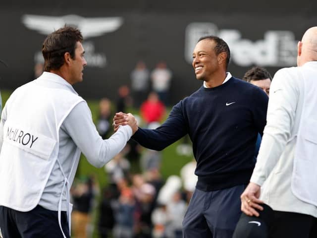 The smile on his face says it all as Tiger Woods shakes hands with Harry Diamond, Rory McIlroy's caddie, after finishing with three straight birdies in the first round of The Genesis Invitational at Riviera Country Club in Pacific Palisades, California. Picture: Michael Owens/Getty Images.