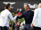 The smile on his face says it all as Tiger Woods shakes hands with Harry Diamond, Rory McIlroy's caddie, after finishing with three straight birdies in the first round of The Genesis Invitational at Riviera Country Club in Pacific Palisades, California. Picture: Michael Owens/Getty Images.