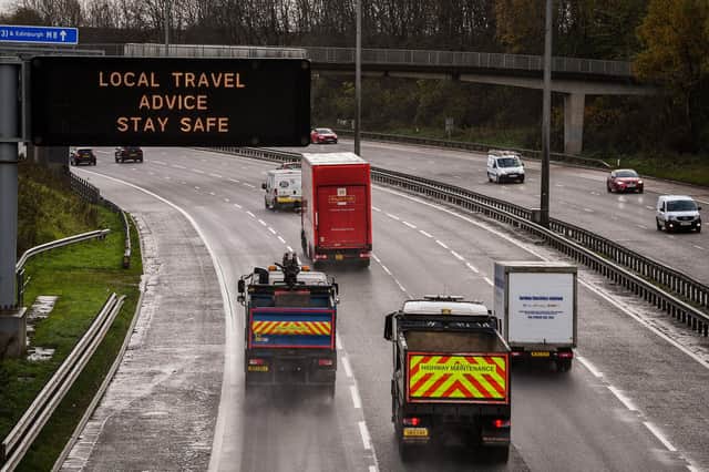 Motorists pass a coronavirus motorway gantry sign on the M8