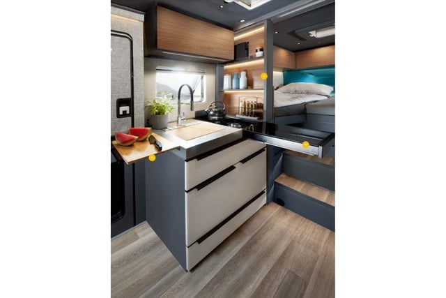 The optional kitchen package includes a pull-out cutting board, a kitchen shelf that electrically folds away when not in use and an extendable working surface.