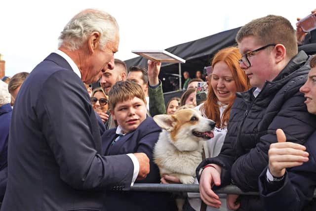 King Charles III meets a member of the public with a corgi dog as he arrives at Hillsborough Castle in Belfast. Picture: Niall Carson/AFP via Getty Images