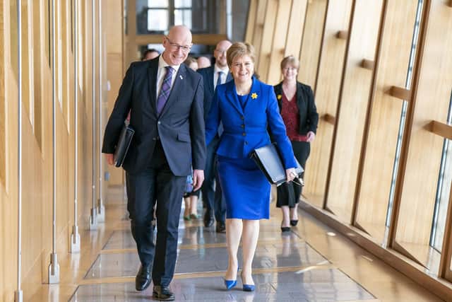 Outgoing First Minister Nicola Sturgeon and outgoing Deputy First Minister John Swinney (left) arrive for her last First Minster's Questions. Picture: Jane Barlow/PA Wire