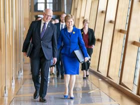 Outgoing First Minister Nicola Sturgeon and outgoing Deputy First Minister John Swinney (left) arrive for her last First Minster's Questions. Picture: Jane Barlow/PA Wire