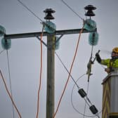 Engineers from Scottish and Southern Electricity Networks repair power lines on January 31, 2022 in Edzell, Scotland. (Photo by Jeff J Mitchell/Getty Images)