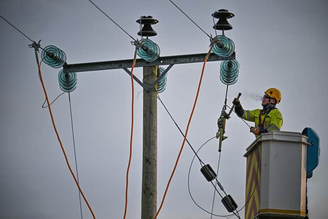 Engineers from Scottish and Southern Electricity Networks repair power lines on January 31, 2022 in Edzell, Scotland. (Photo by Jeff J Mitchell/Getty Images)