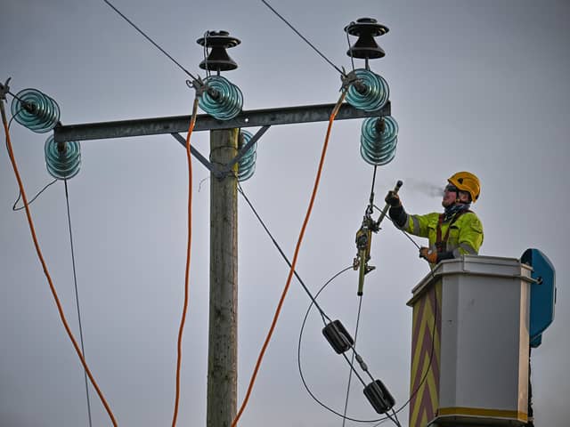 Engineers from Scottish and Southern Electricity Networks repair power lines on January 31, 2022 in Edzell, Scotland. (Photo by Jeff J Mitchell/Getty Images)