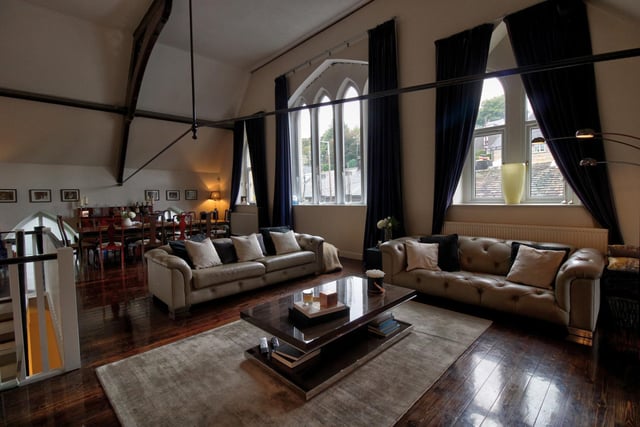 The truly magnificent living room has impressive proportions with a high vaulted ceiling showcasing superb timbers and showing the character of this former church.