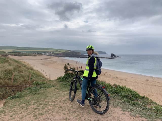 E-biking with views of Thurlestone Rock, an arch shaped formation off the coast of South Devon.