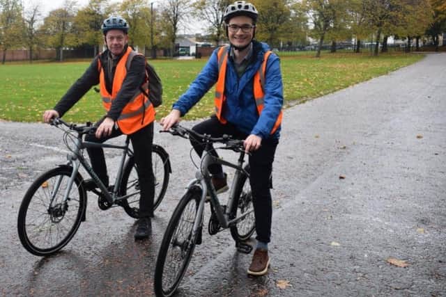 Glasgow City Council transport convener Angus Millar, right, being taught to cycle by Bikeability instructor Tim Pearson. Picture: Glasgow City Council