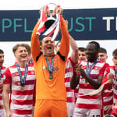 Man-of-the-match Ryan Fulton lifts the SPFL Trust Trophy after a tremendous performance against Raith Rovers.