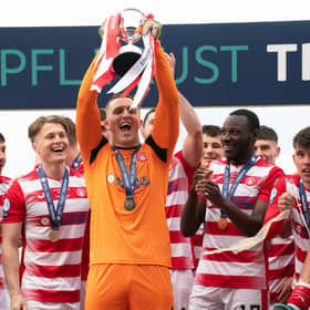 Man-of-the-match Ryan Fulton lifts the SPFL Trust Trophy after a tremendous performance against Raith Rovers.