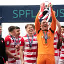 Man-of-the-match Ryan Fulton lifts the SPFL Trust Trophy after a tremendous performance against Raith Rovers.